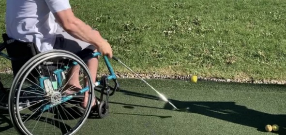 Man in Wheelchair Swing Golf Club