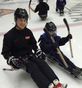 1 adult 1 child sitting in sleds