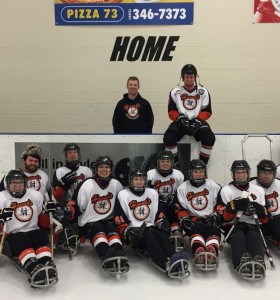 many people playing sledge hockey